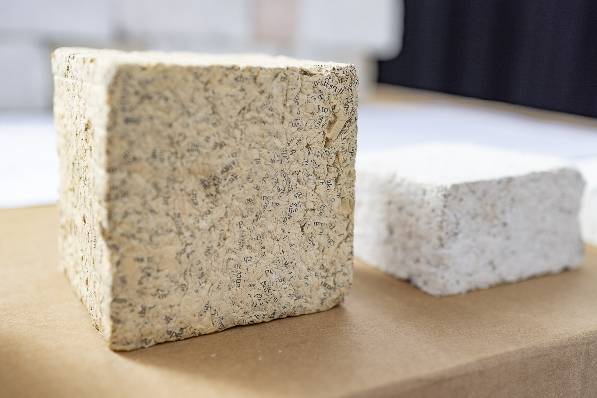 Circular building material made from recycled books, applied as an innovative material in office design.