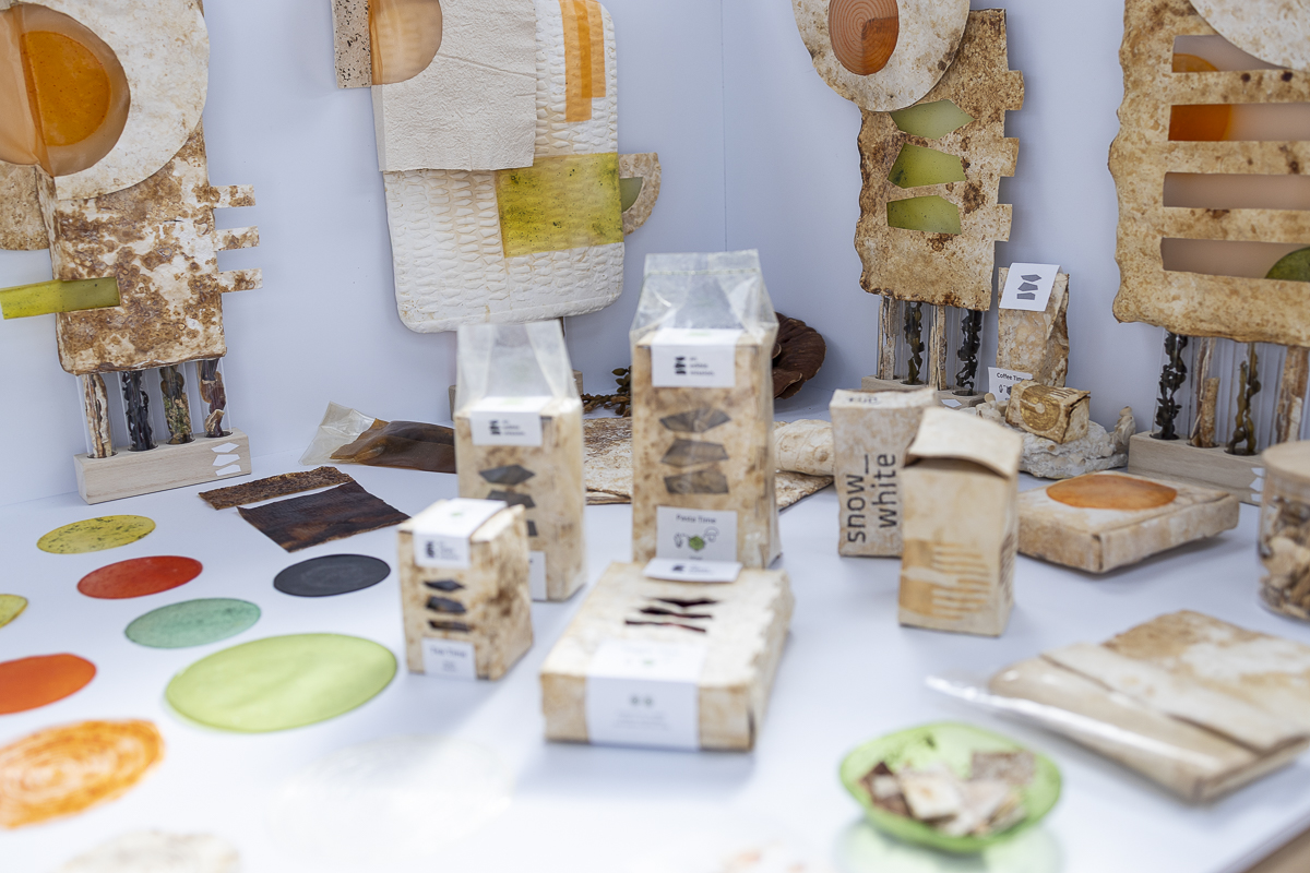 Overview of experimental biomaterials and material samples with natural colors and textures, presented as inspiration for materials in office design.
