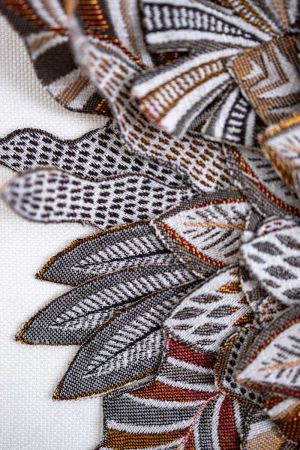 Hand-cut textile layers reinforced with floral wire for wall objects